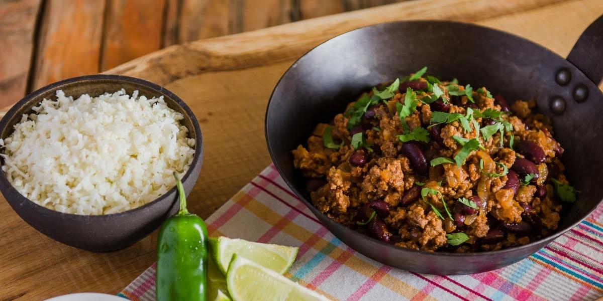 Low-carb chilli con carne in pan with cauliflower rice