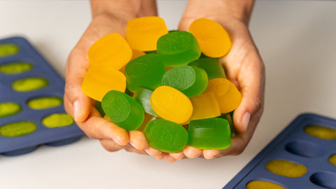 Hands Holding Mango and Lime Gummies