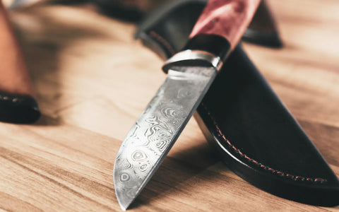 A fixed blade Damascus steel knife with wooden handle