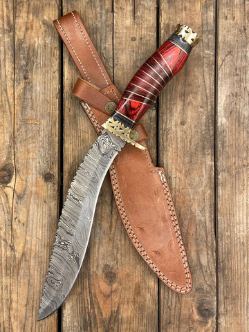 An ornate Damascus steel hunting Kukri with a red handle
