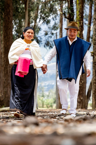Cesar & Teresa, artisans who work with tagua nut making it into jewellery, walk hand in hand through the forest in the north of Ecuador