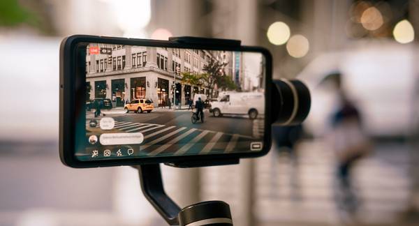 An Oppo phone with the camera app open filming a city intersection.