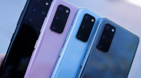 Black, pink, light blue and dark blue Samsung Galaxy phones lined up together