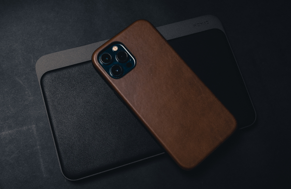 An iPhone 15 face down with a brown leather case