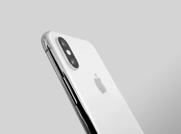 White iPhone X side on with the back showing 