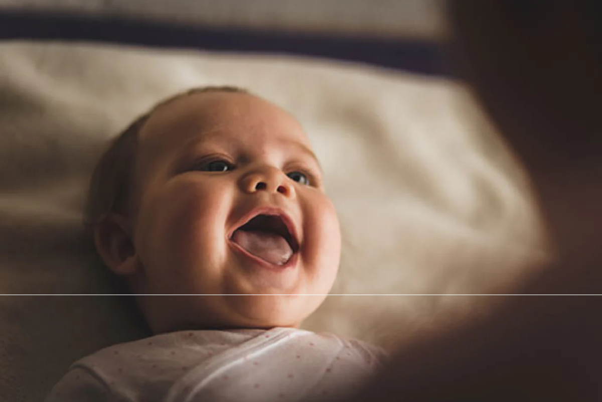 Happy baby smiling in crib