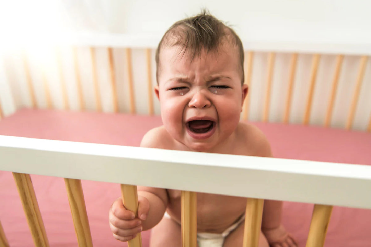 Baby crying in cot