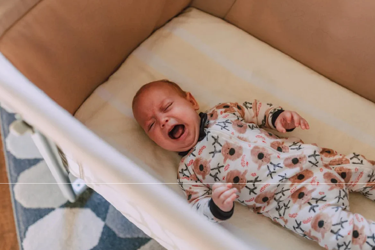 Baby upset crying in cot