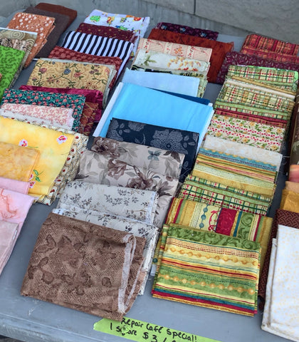 An assortment of colourful quilting cotton squares which were on sale at our Repair Cafe! As marked on the bright green tape, we had "Repair Cafe Special" sales on for the fabric from our Eco Fabric Boutique!