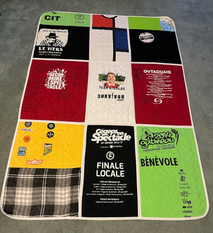 A picture of a quilt made from upcycled shirts by one of our Sewing for Jobs graduates.