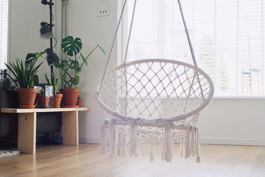 natural rope swing chair in a well-lit area