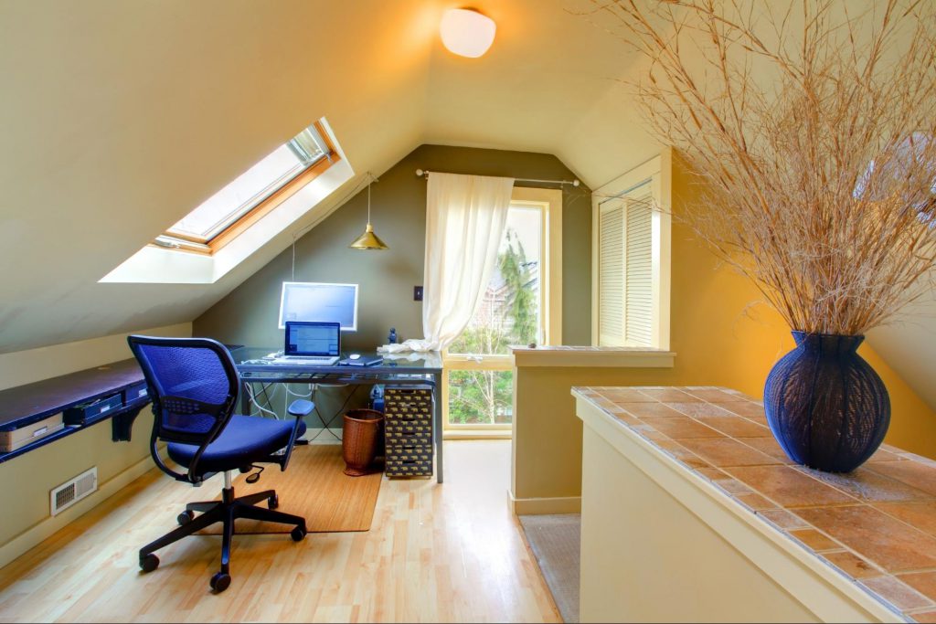 an cozy, ambient home office setting in the attic equipped with a desk and a task chair