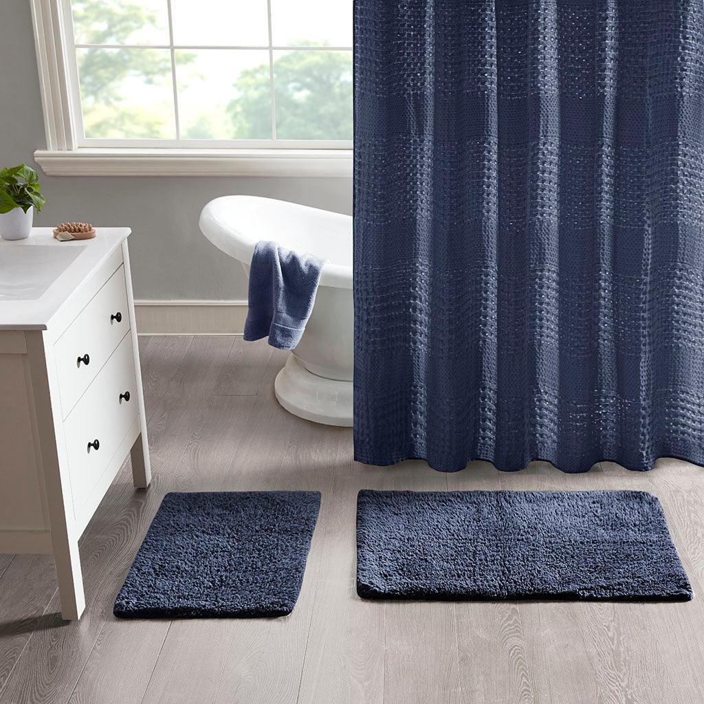 https://cdn.shopify.com/s/files/1/0458/7513/4624/files/ritzy-bath-rug-navy-olliix-com-casaone-1.jpg?v=1686664272&width=1024