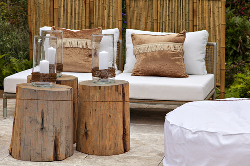 Wooden outdoor furniture including coffee tables in a cosy setting