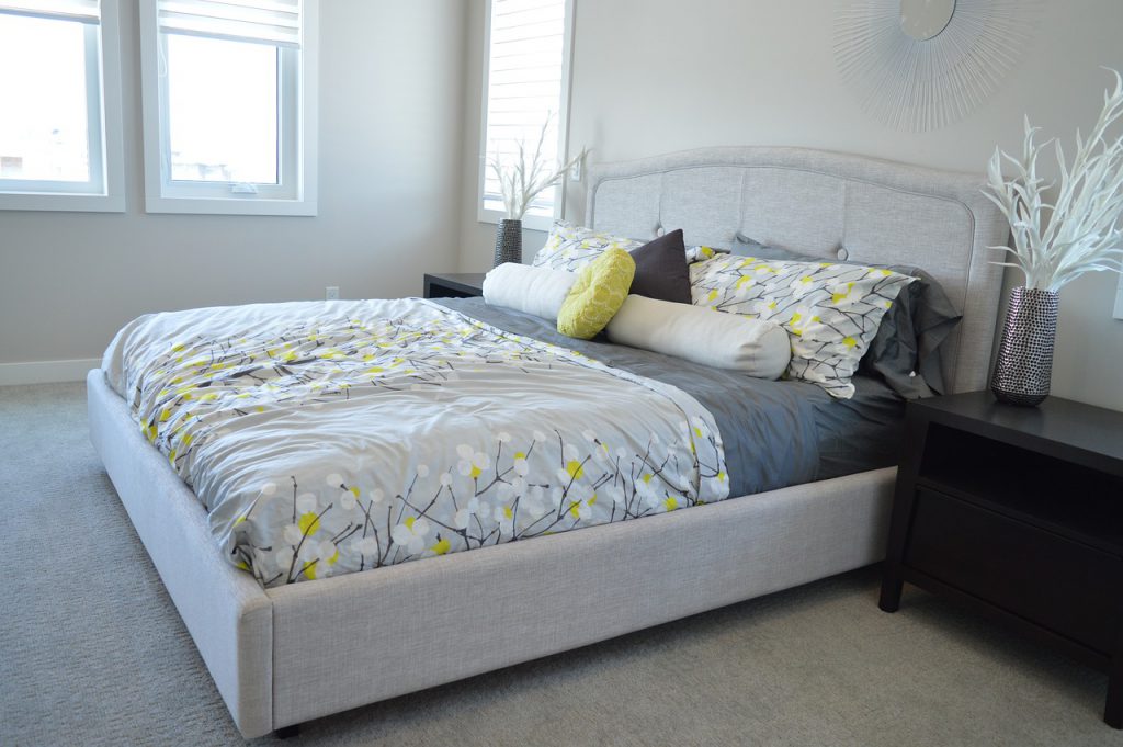 new apartment white bed with fabric headboard