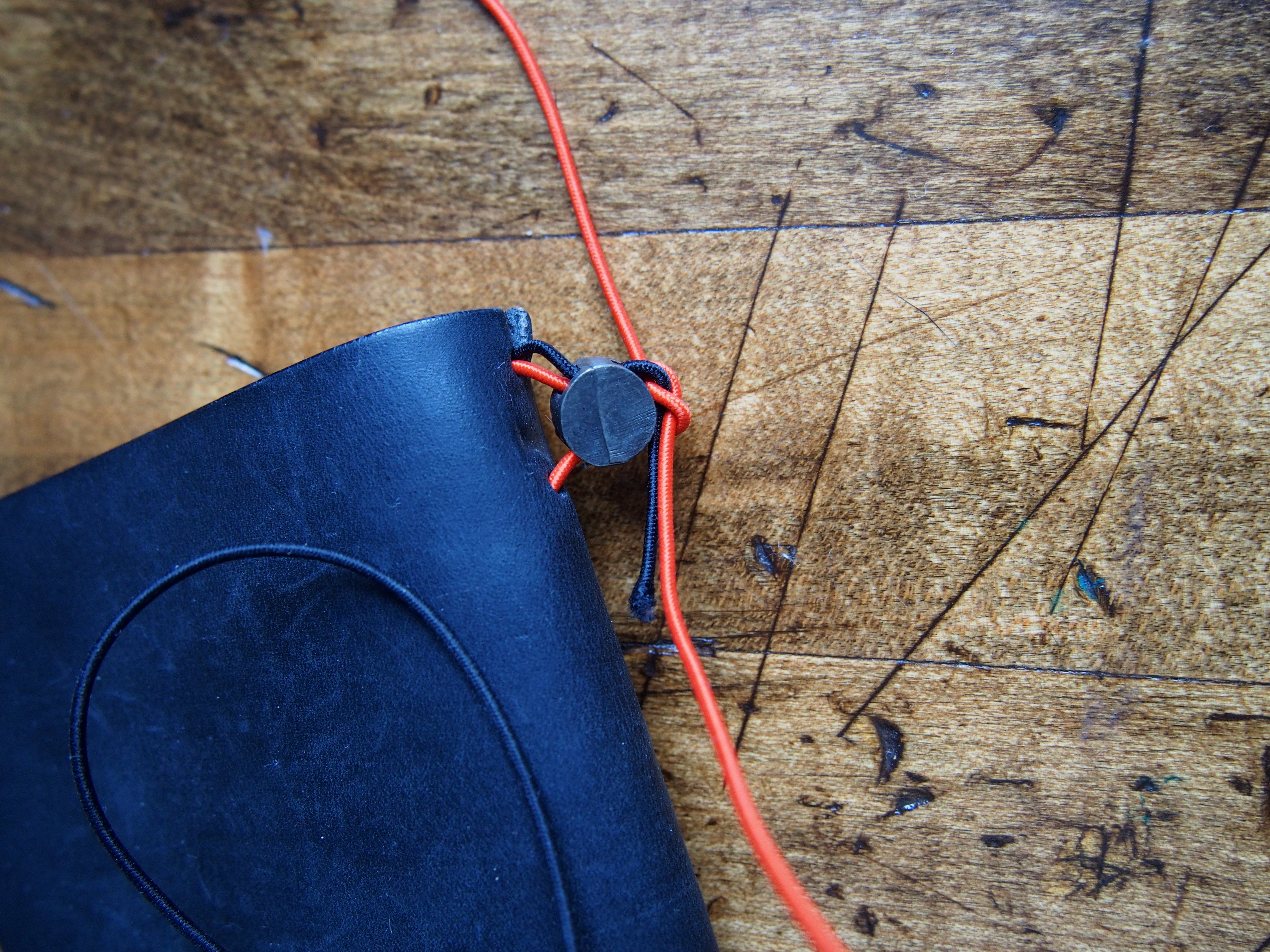Step 7: Tie a knot. You'll be able to adjust the tightness now. And it's now or never, so take the time to make sure it's how you like. Better to err on the side of tightness, since the elastics can loosen up over time, but if it's too loose, you'll have to re-do the whole thing. 