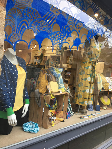 Clothing shop window with blue and yellow theme