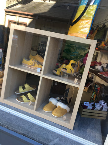 Shoe shop window with yellow footwear displayed