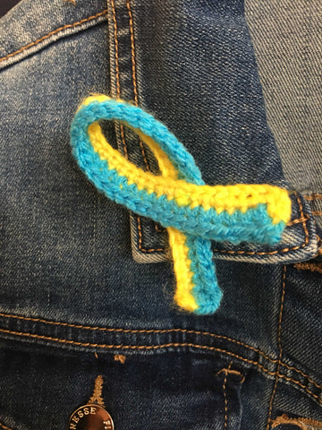 Crocheted pin on ribbon in the colours of the Ukrainian flag