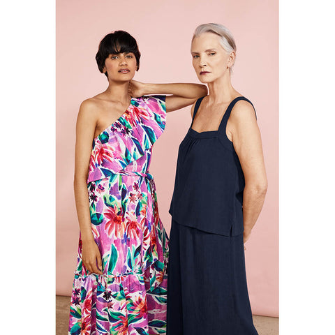 Two models - Dark haired woman wearing flowery summer dress, grey haired woman wearing plain navy blue summer dress