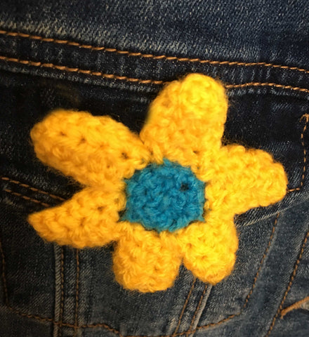 Crocheted flower in yellow and blue of the Ukrainian flag