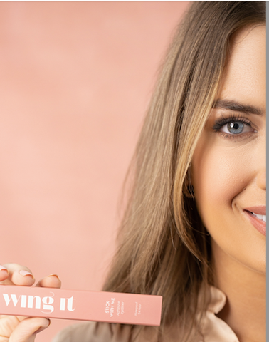 Woman holding adhesive eyeliner