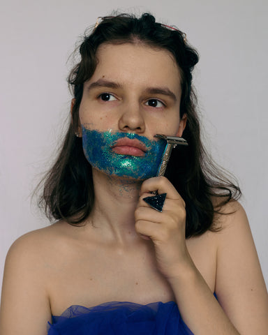 Woman wondering if her hair will grow back thicker after dermaplaning while having a glitter beard