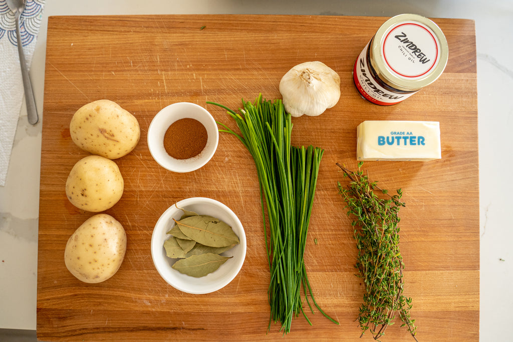 Ingredients for Zindrew's Garlic Chili Oil Mashed Potatoes on a Cutting Board