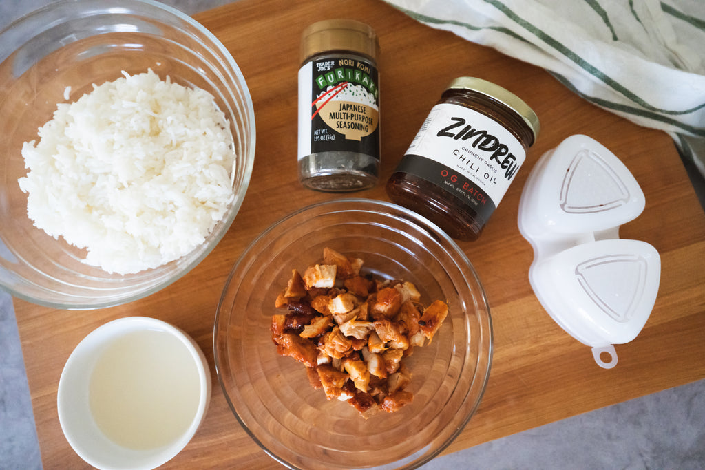 ingredients to make Zindrew Crunchy Garlic Chili Oilfurikake rice balls laid out on a cutting board