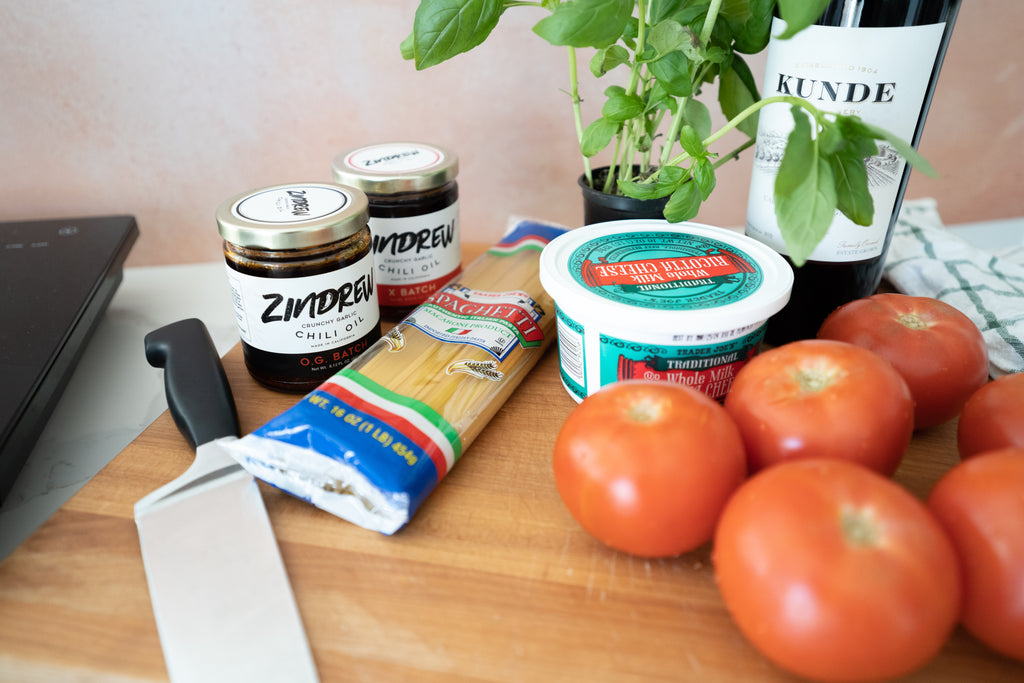 ingredients to make Zindrew's Zesty Ricotta Pasta on a cutting board