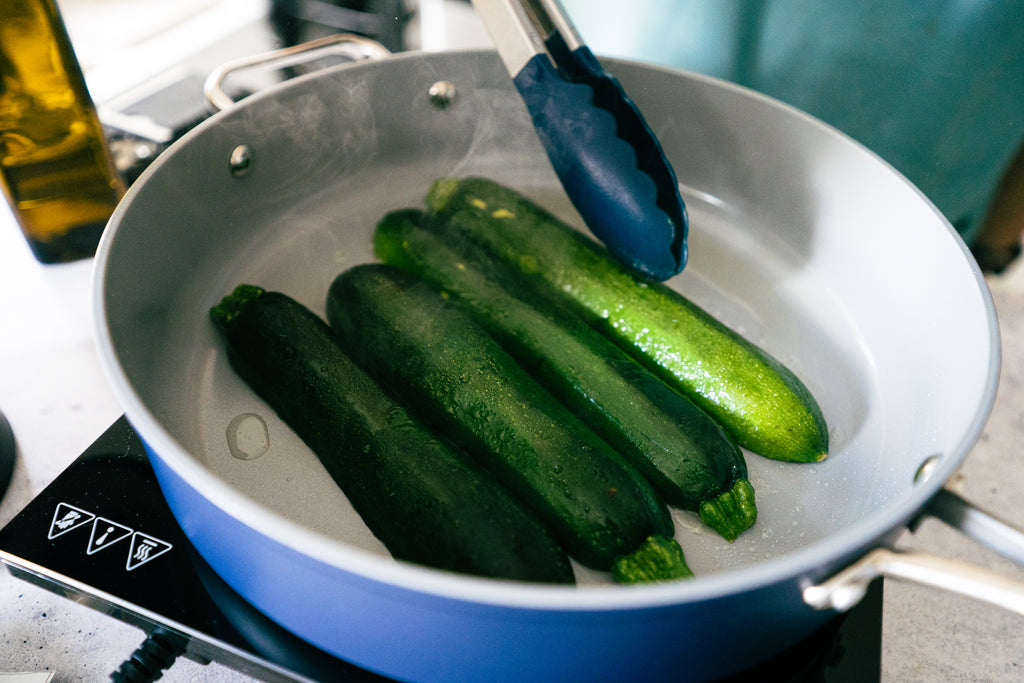 zucchini being seared on a pan
