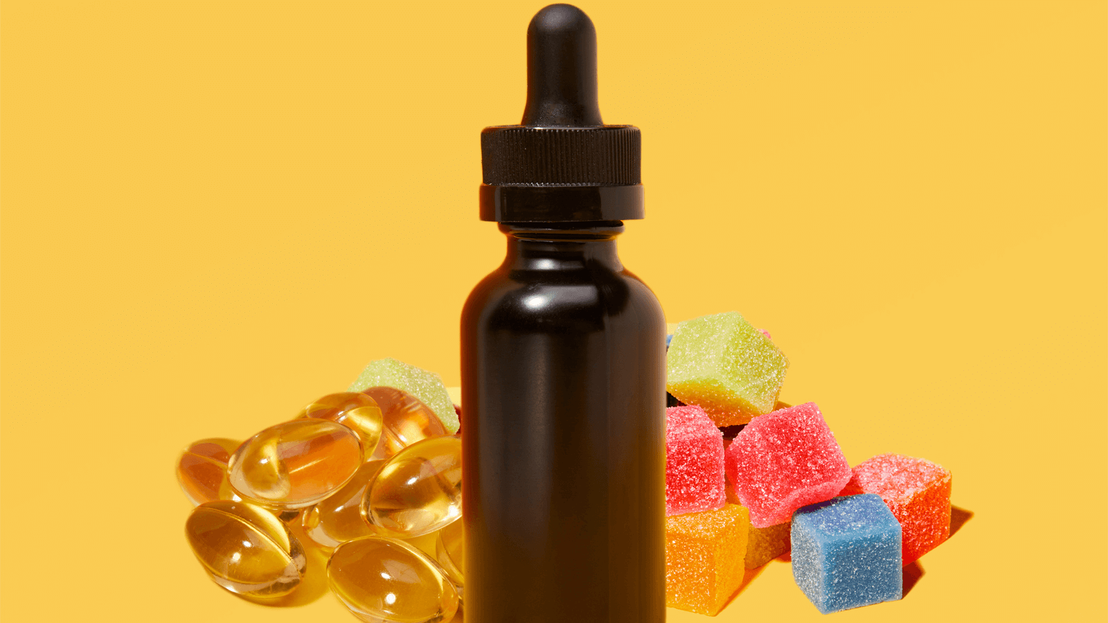tincture bottle with gummies surrounding it