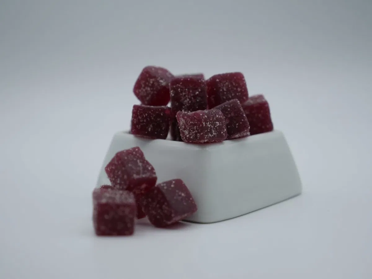 pile pf purple gummies sitting on top of a stand