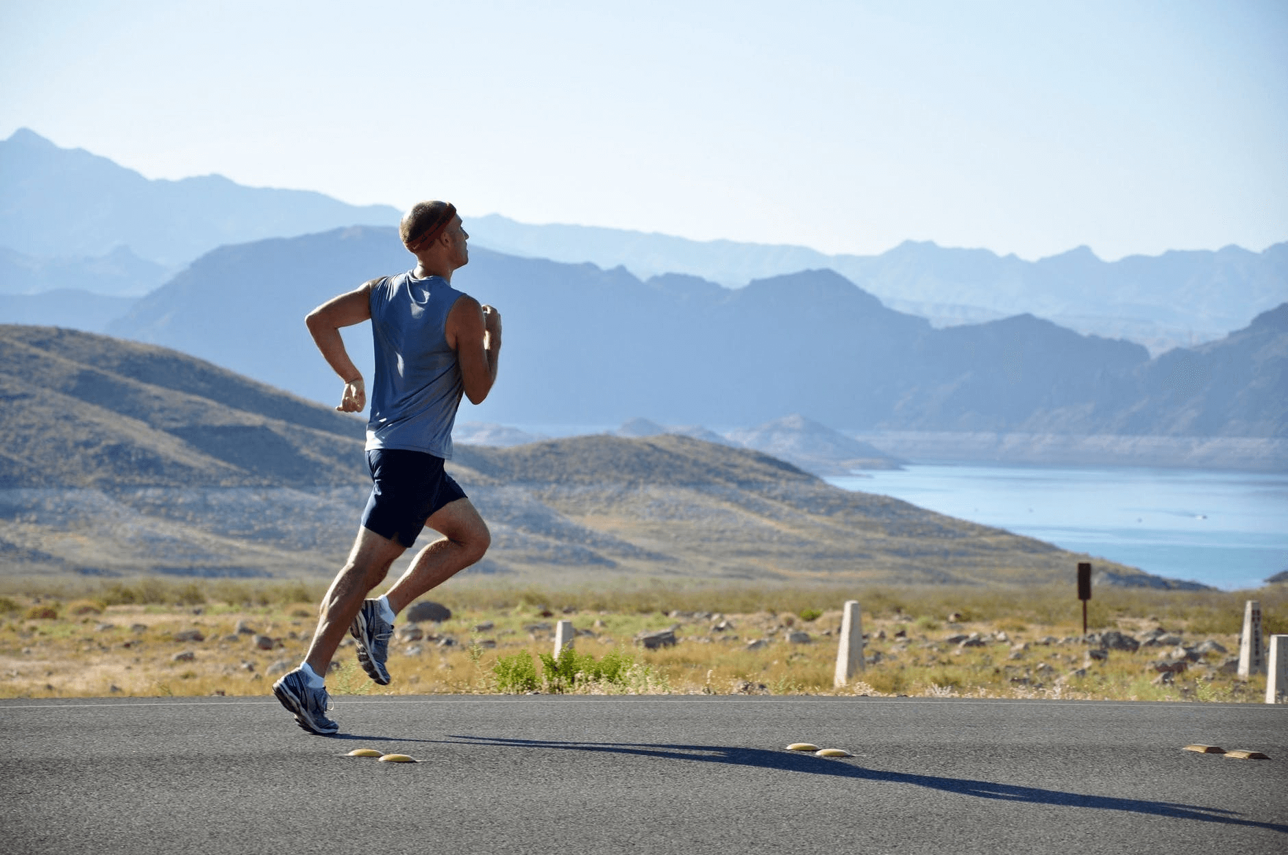 person running in front of mountain range