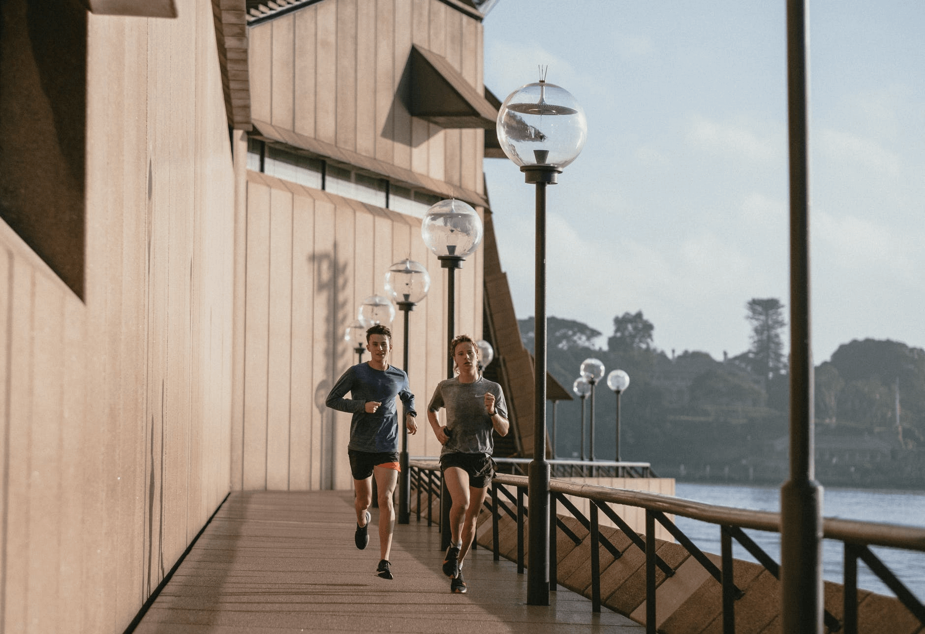 man and woman running across dock