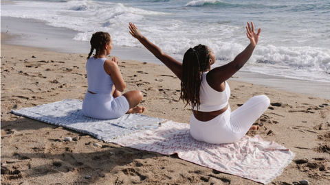 Two women on a beach with good posture.