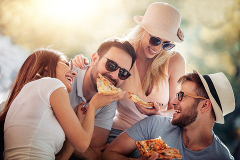 People enjoying pizza without the worry of food intolerances