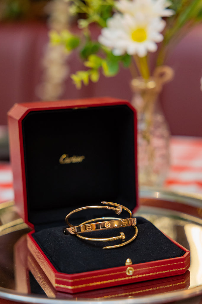 Image of Cartier love bracelets and two Cartier Just en Clout bracelets.