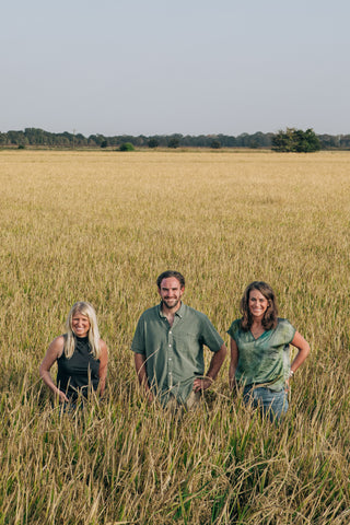 Owners of Two Brooks Farms in a field