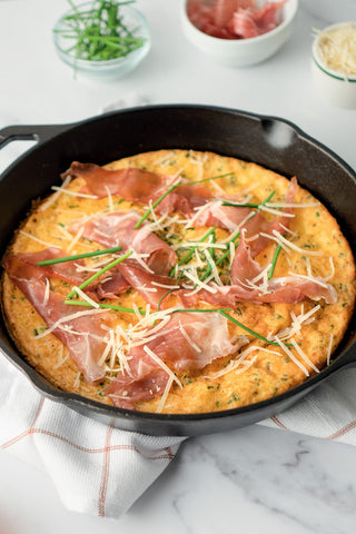 Hot honey dutch baby topped with proscuitto and parmesan