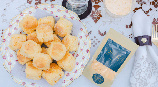 Hostess Provisions Pimento Cheese Seasoning nest to a plate of biscuits