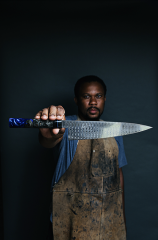 Quintin Middleton with a knife he crafted