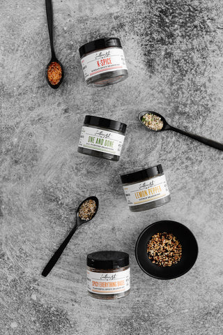 Southern Art Co spices in spoons and their branded containers
