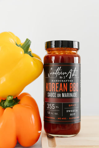 Southern Art Co korean bbq sauce in a bottle next to bell peppers