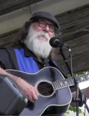 Bear Berends playing guitar on stage.