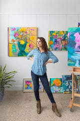 Colleen Gleason Shull standing before paintings. 