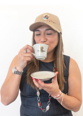 Paola Andrea Carlson tastes Pochis' coffee. 