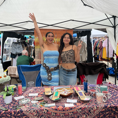 Alexis and Jade selling tea outdoors.