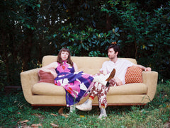 Viv & Riley sitting on a couch outdoors.