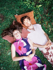 Viv & Riley lying on pillows in grass.